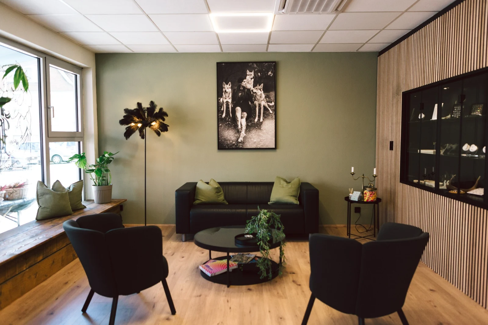Sofa mit grünen Kissen und Kunst an der Wand im echten Studio